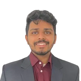 A man in a suit and red shirt is smiling for the camera.