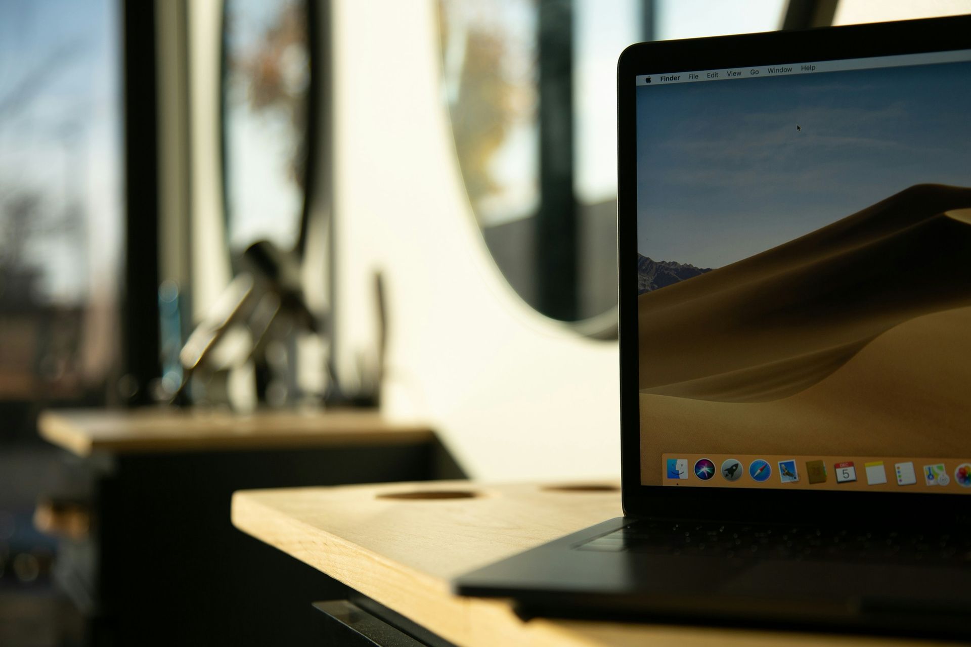 A laptop computer is sitting on a wooden table.