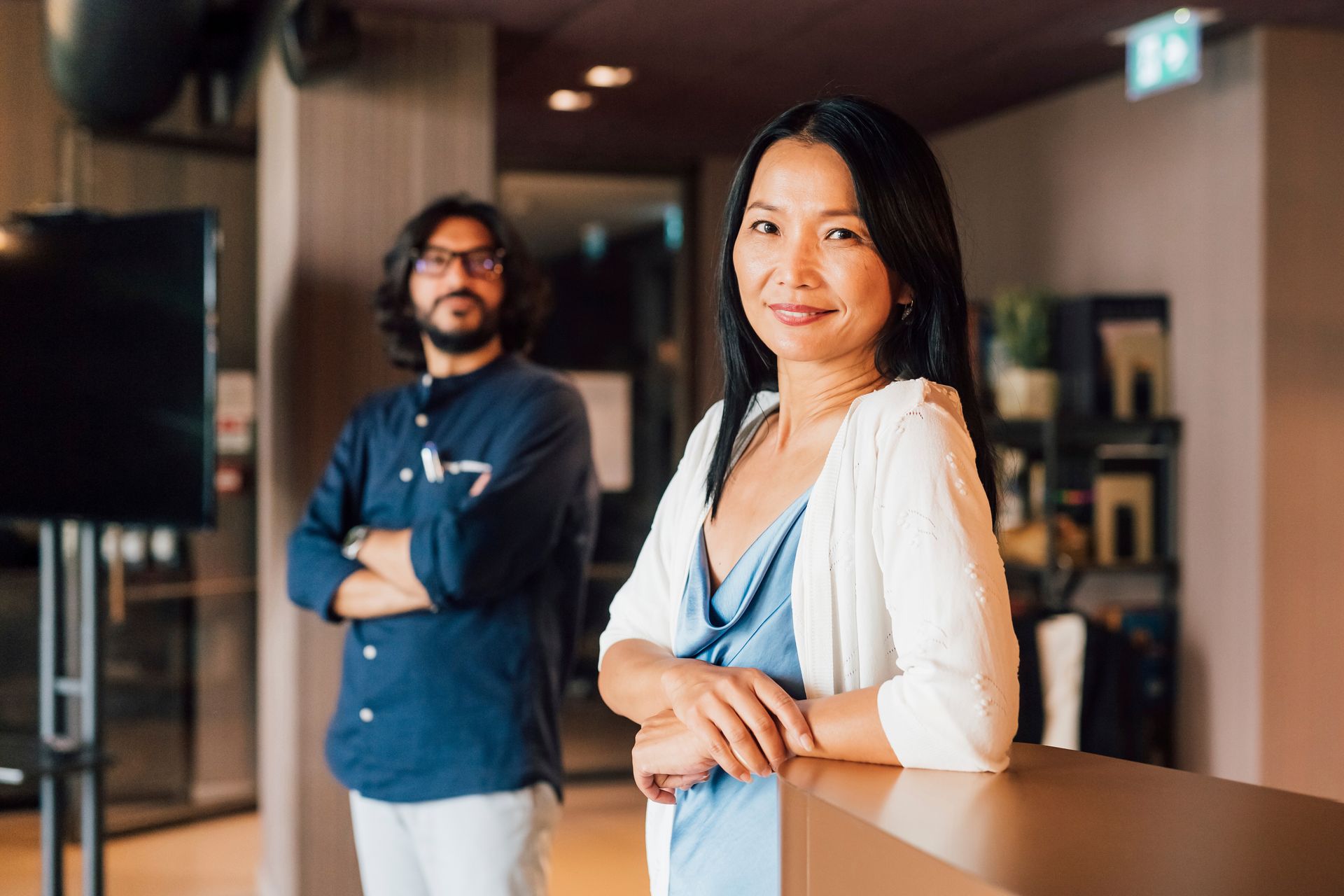 A man and a woman are standing next to each other in a room.