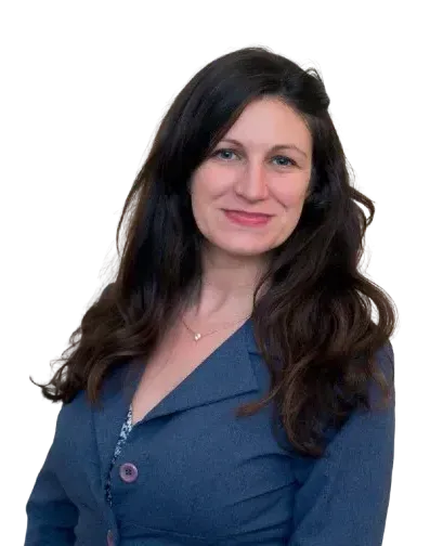 A woman with long dark hair is wearing a blue jacket