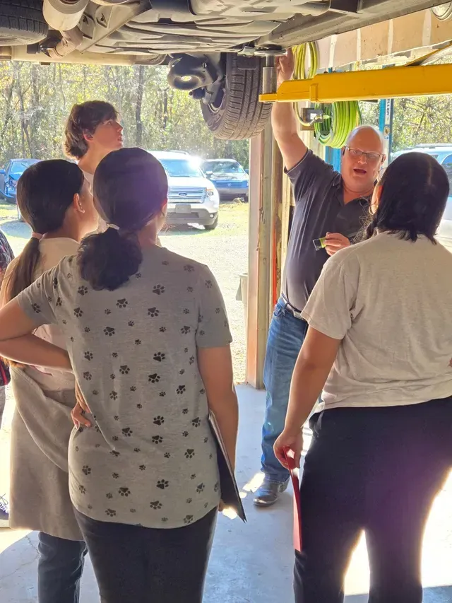 Customers Touring Auto Repair Shop And Service Area | Rock's Tire & Auto