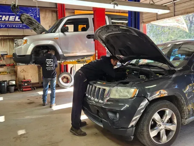 Technician Working On SUV Engine Inside Auto Repair Shop | Rock's Tire & Auto