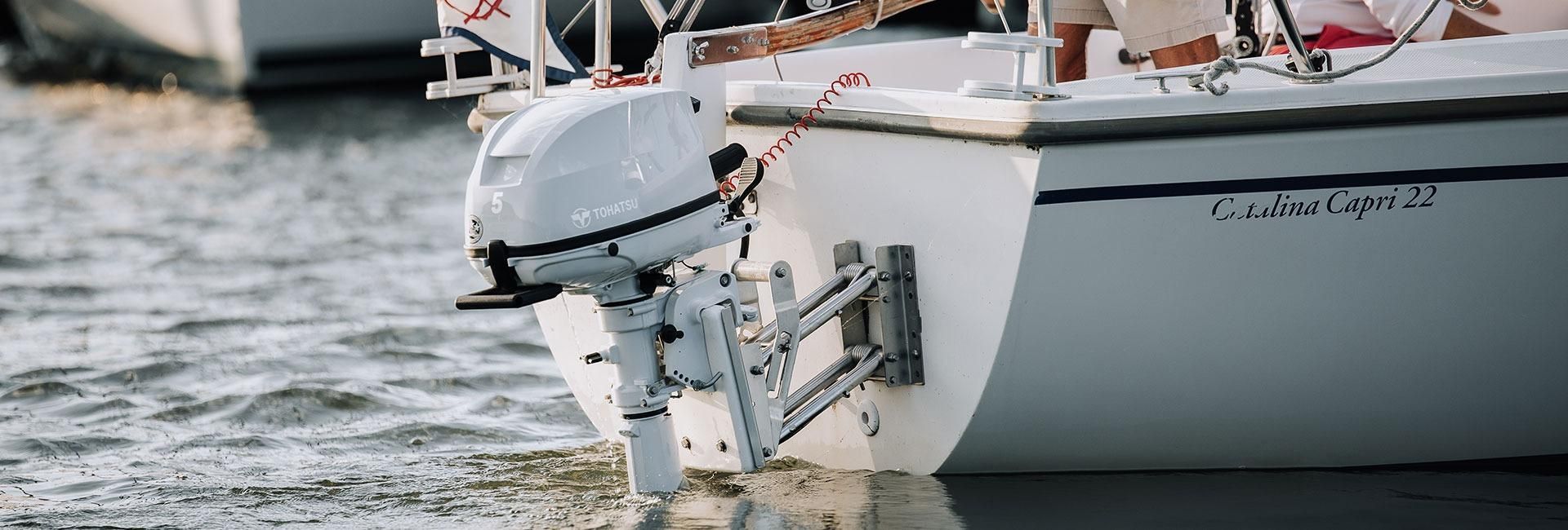 A White Boat With A Motor Is Floating On Top Of A Body Of Water — Cannonvale Marine In Jubilee Pocket, QLD