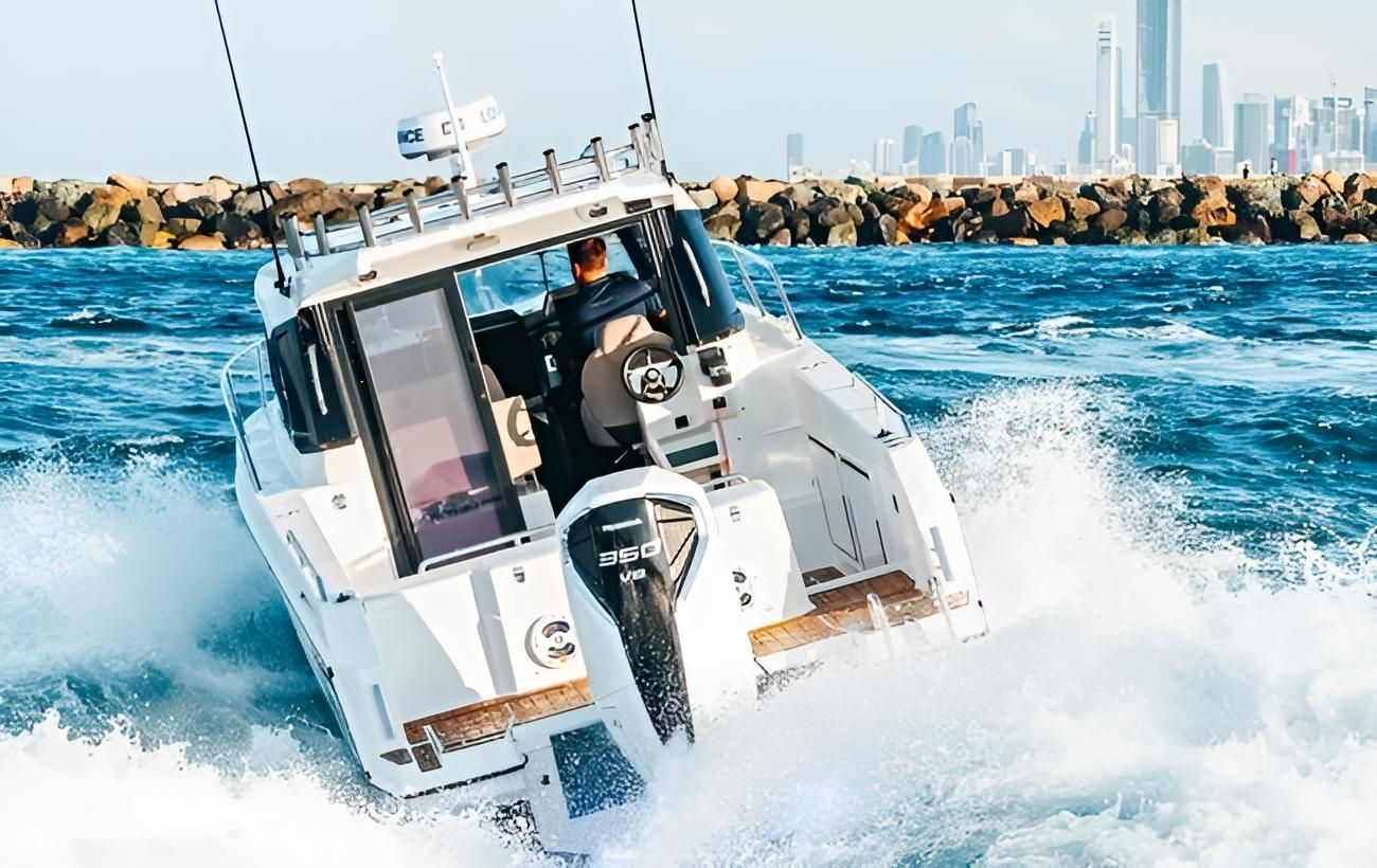 A White Boat Is Floating On Top Of A Body Of Water — Cannonvale Marine In Jubilee Pocket, QLD