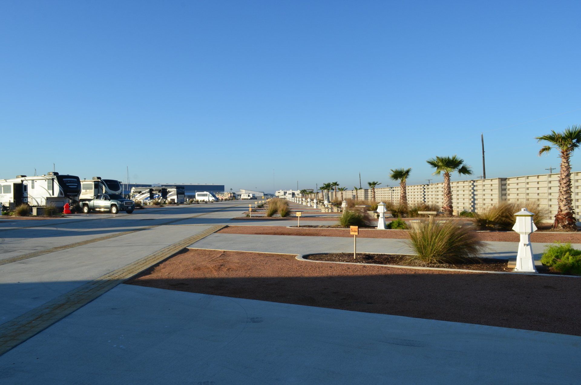 A lot of rv 's are parked in a parking lot