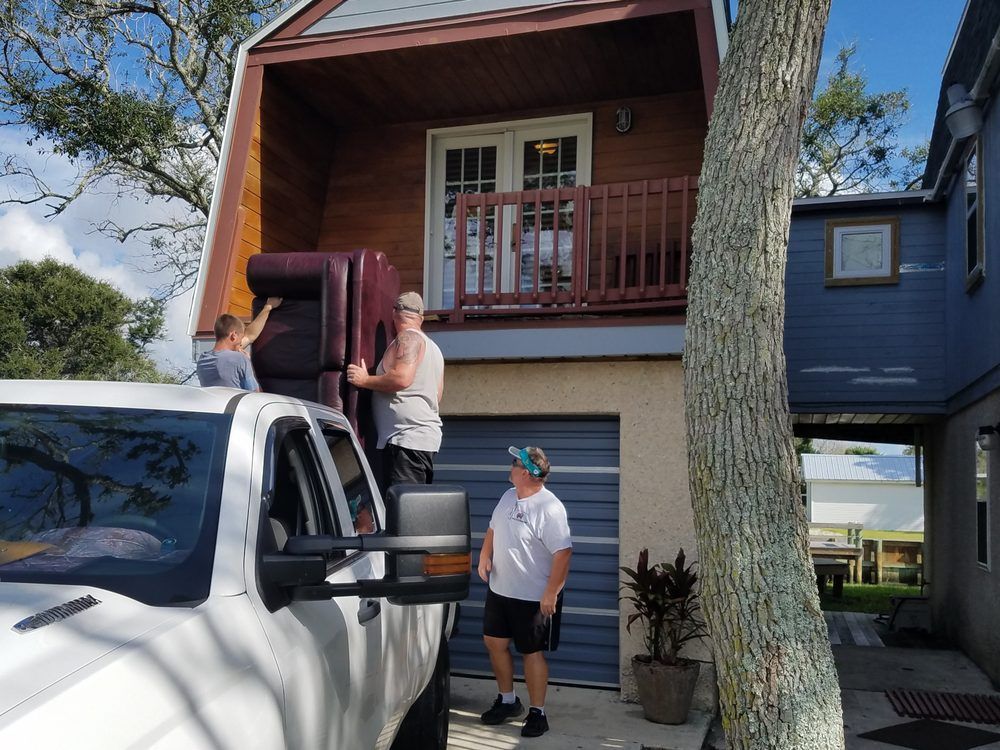 A white truck is parked in front of a house