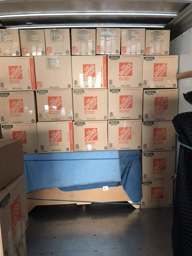 A bunch of home depot boxes stacked on top of each other