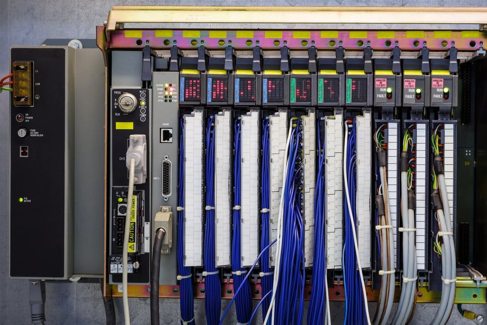 Server Rack With Circuit Boards, Connected by Blue and Gray Cables — Darwin Electrical Services in Humpty Doo, NT