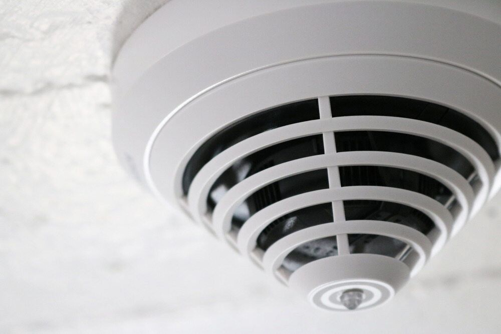 White Smoke Detector Mounted on a White Ceiling — Darwin Electrical Services in Humpty Doo, NT