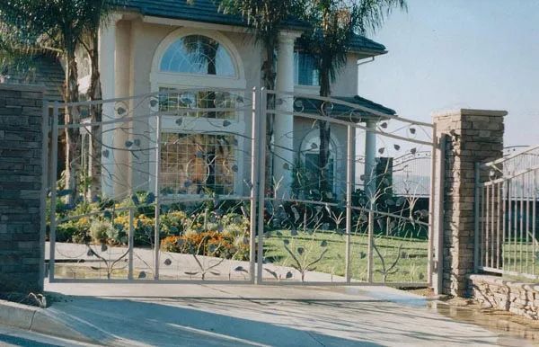 A large house with a sliding gate in front of it