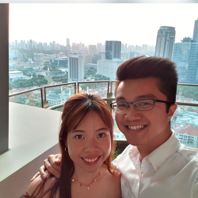 Photo of Jun Yew and his wife, Nikki, with a view of Singapore's Cityscape.