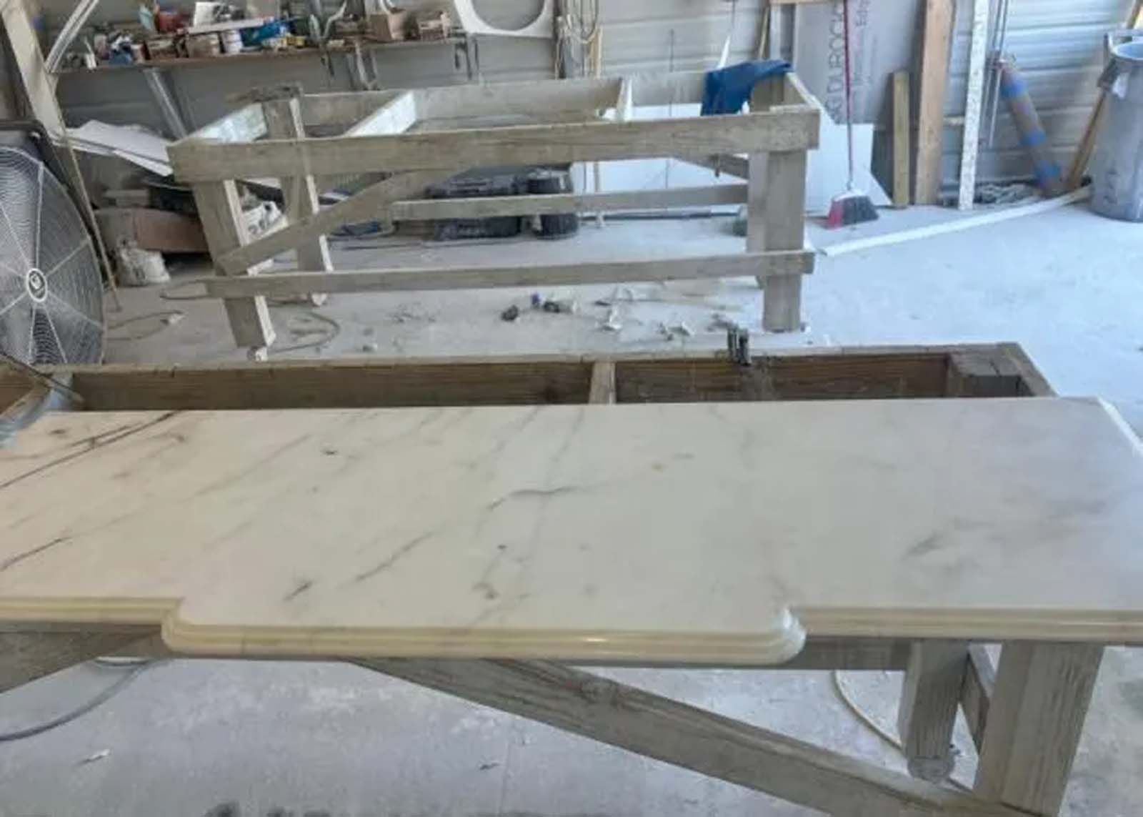 A white table is sitting on top of a wooden table in a room.
