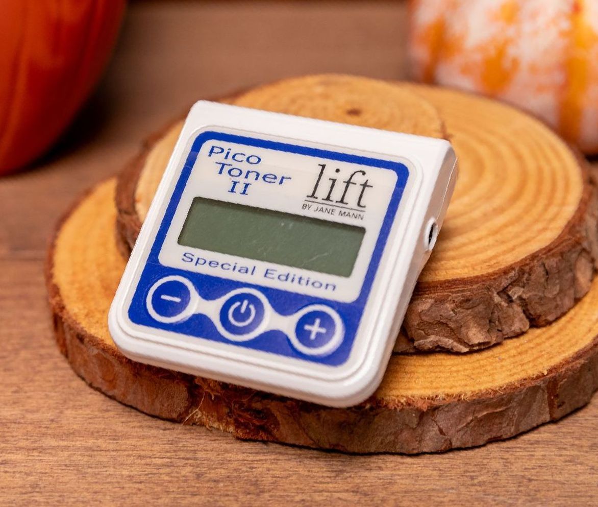 A pico toner lift is sitting on a piece of wood