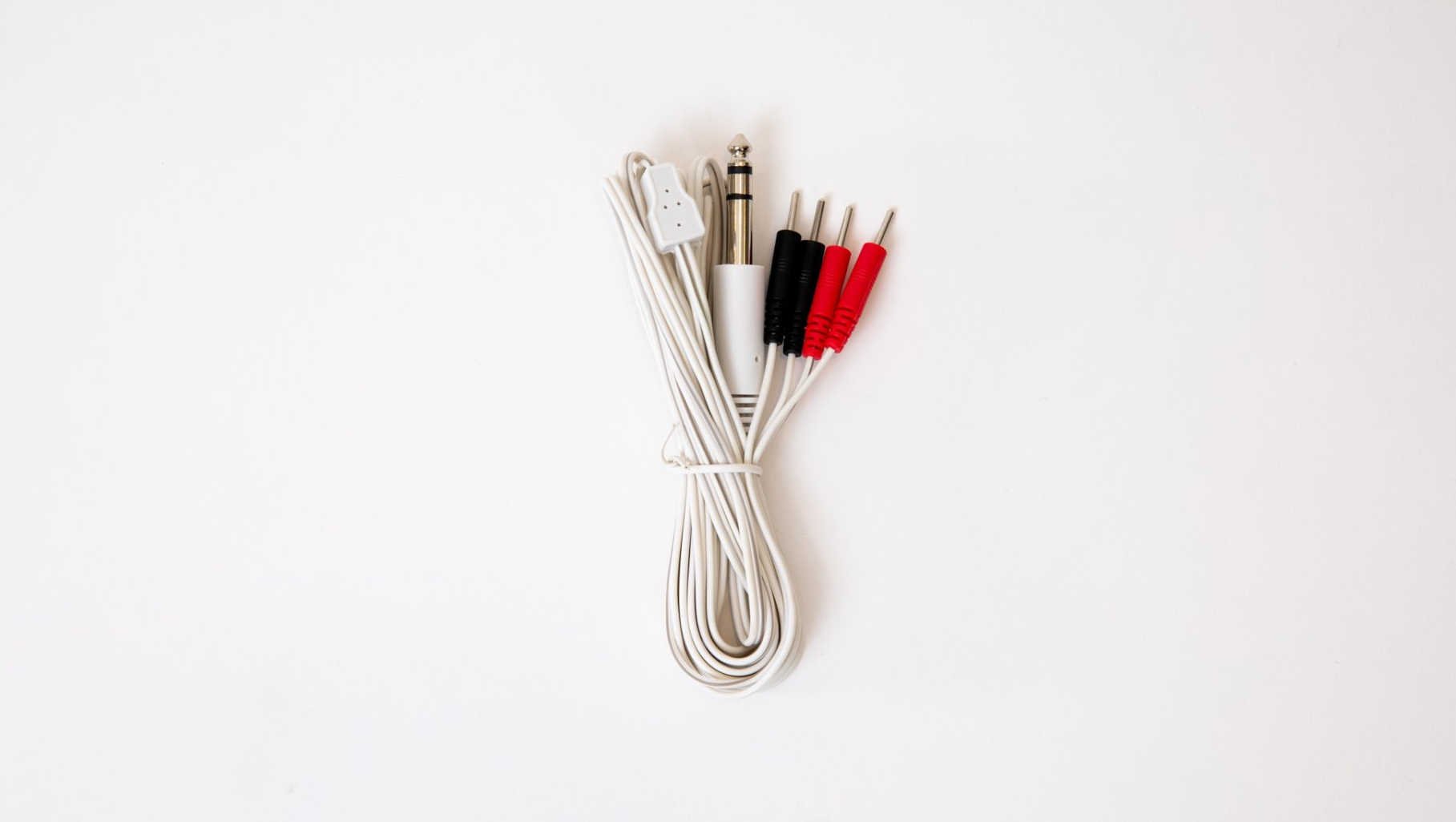 A bunch of wires are sitting on top of each other on a white surface.