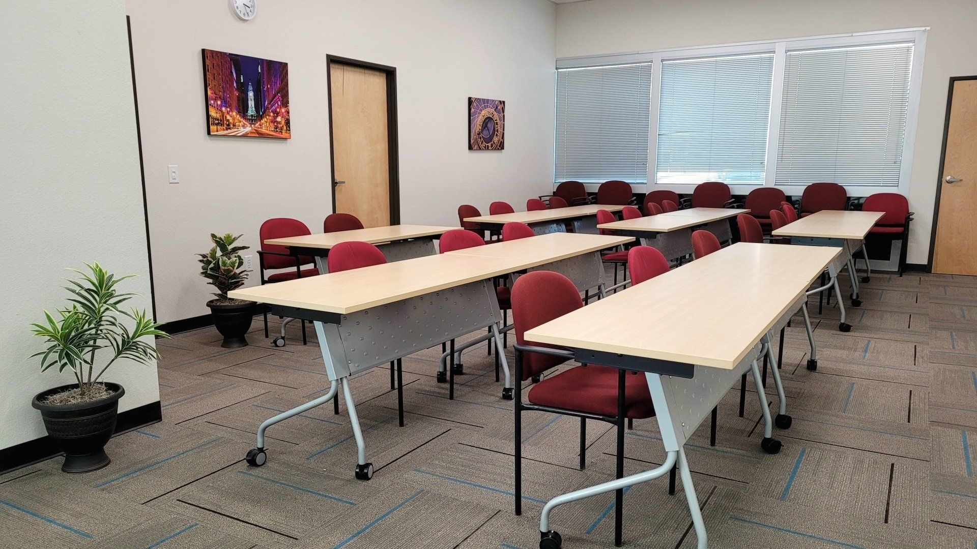 A classroom with a lot of tables and chairs