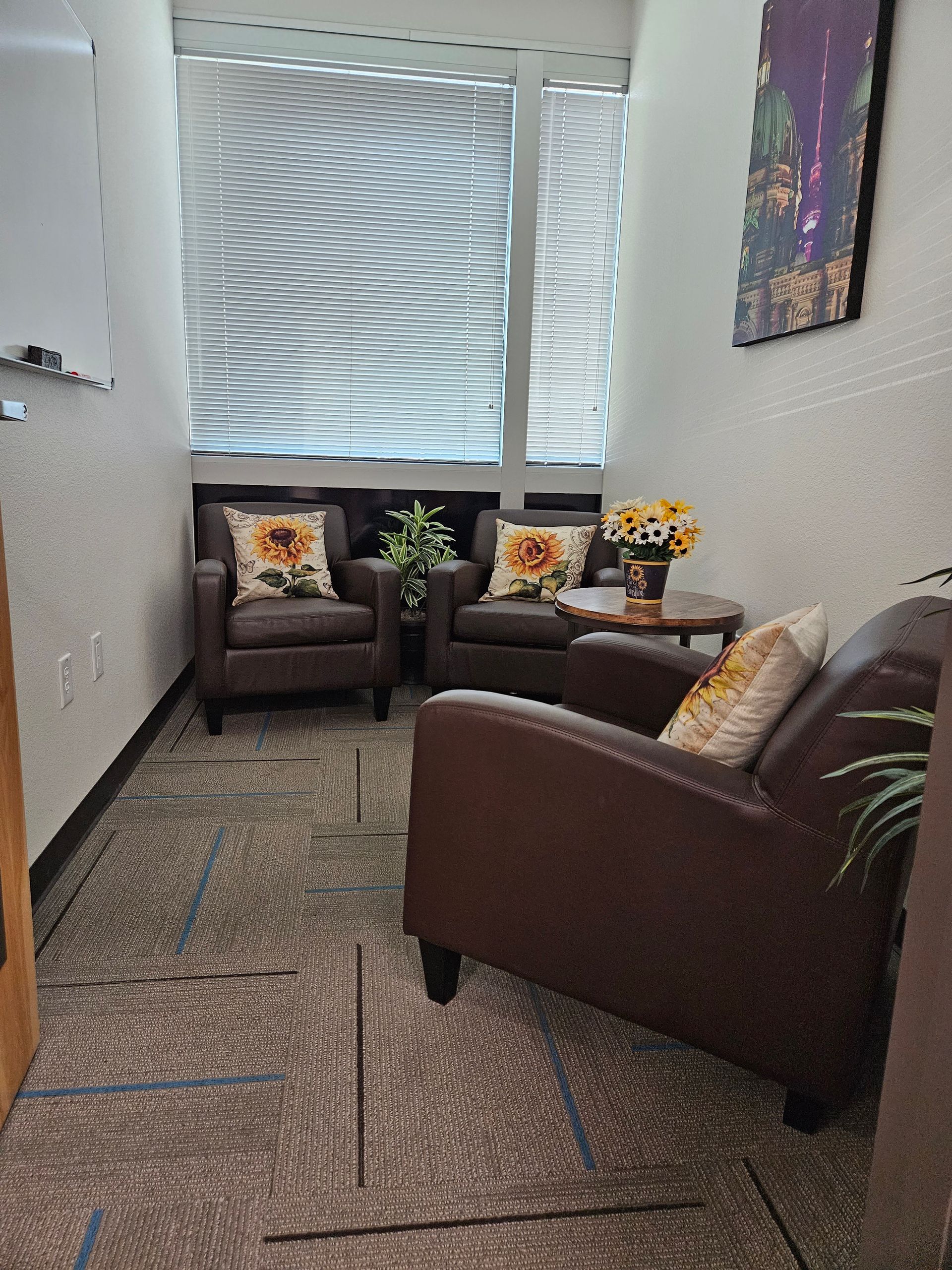 There are two chairs and a table in the room.