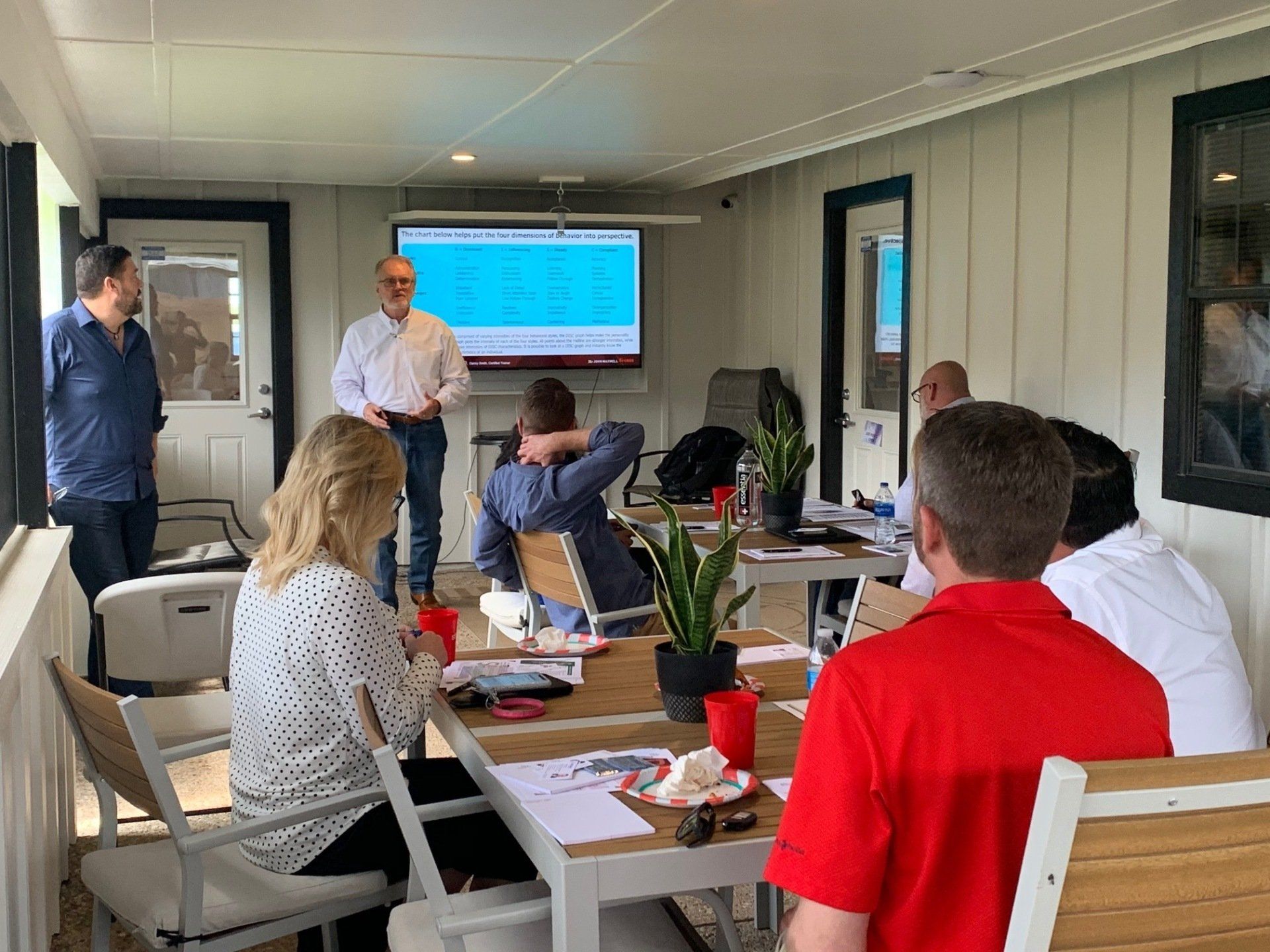 A group of people are sitting around a table in a room.