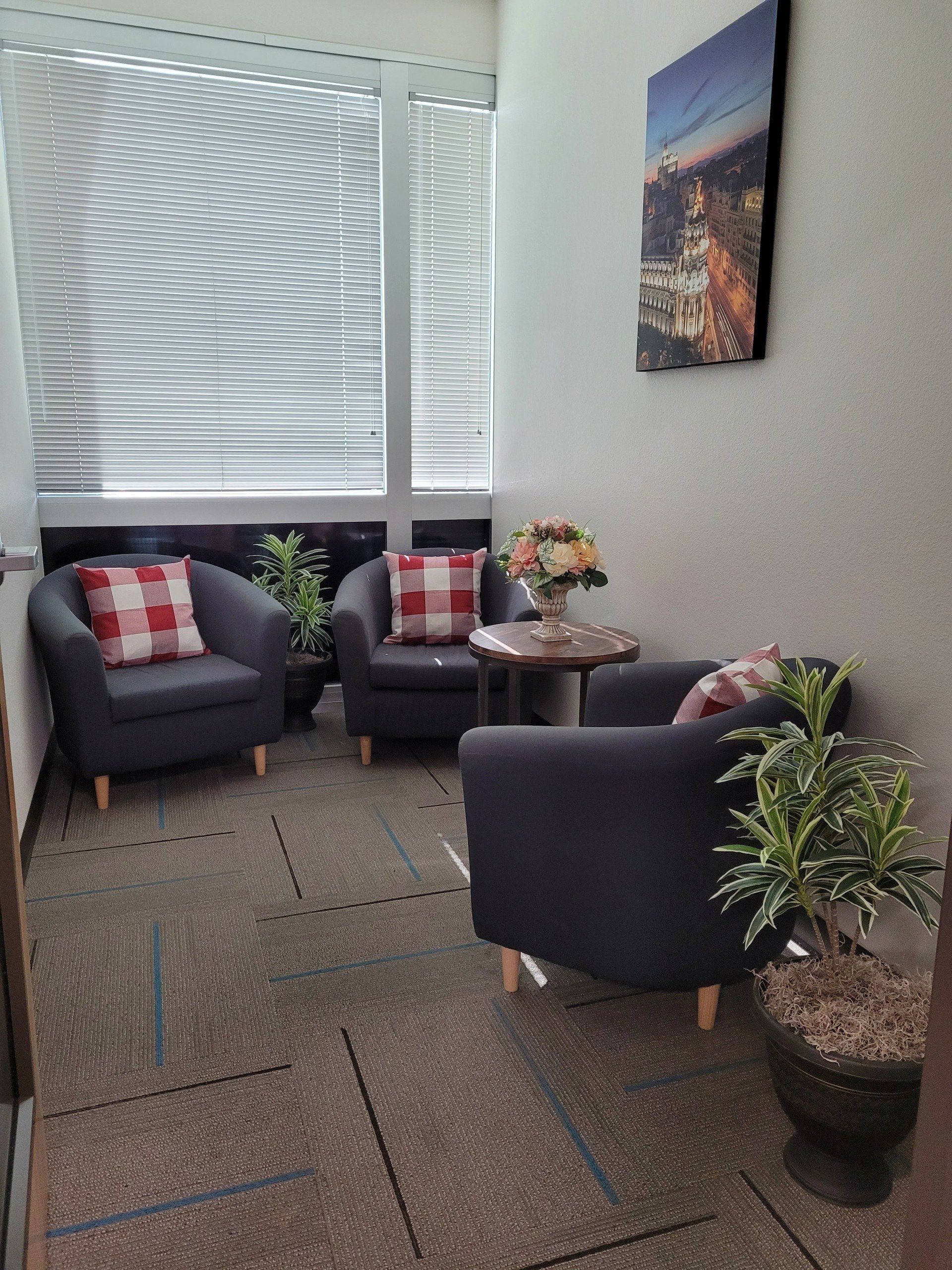 There are two chairs and a table in the room.