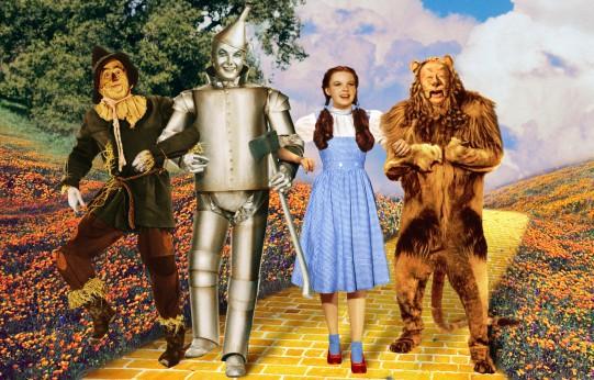 The wizard of oz characters are standing on a yellow brick road.