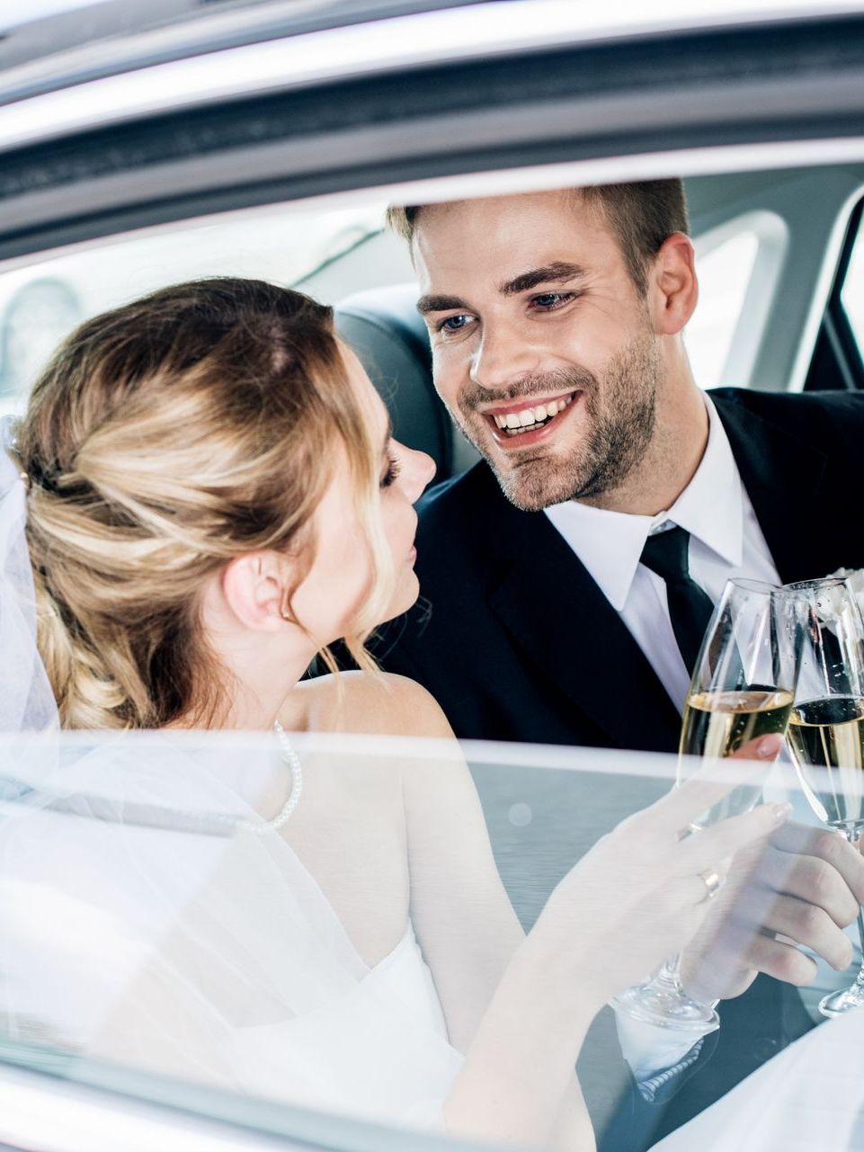 bride and groom sitting in a comfortable car