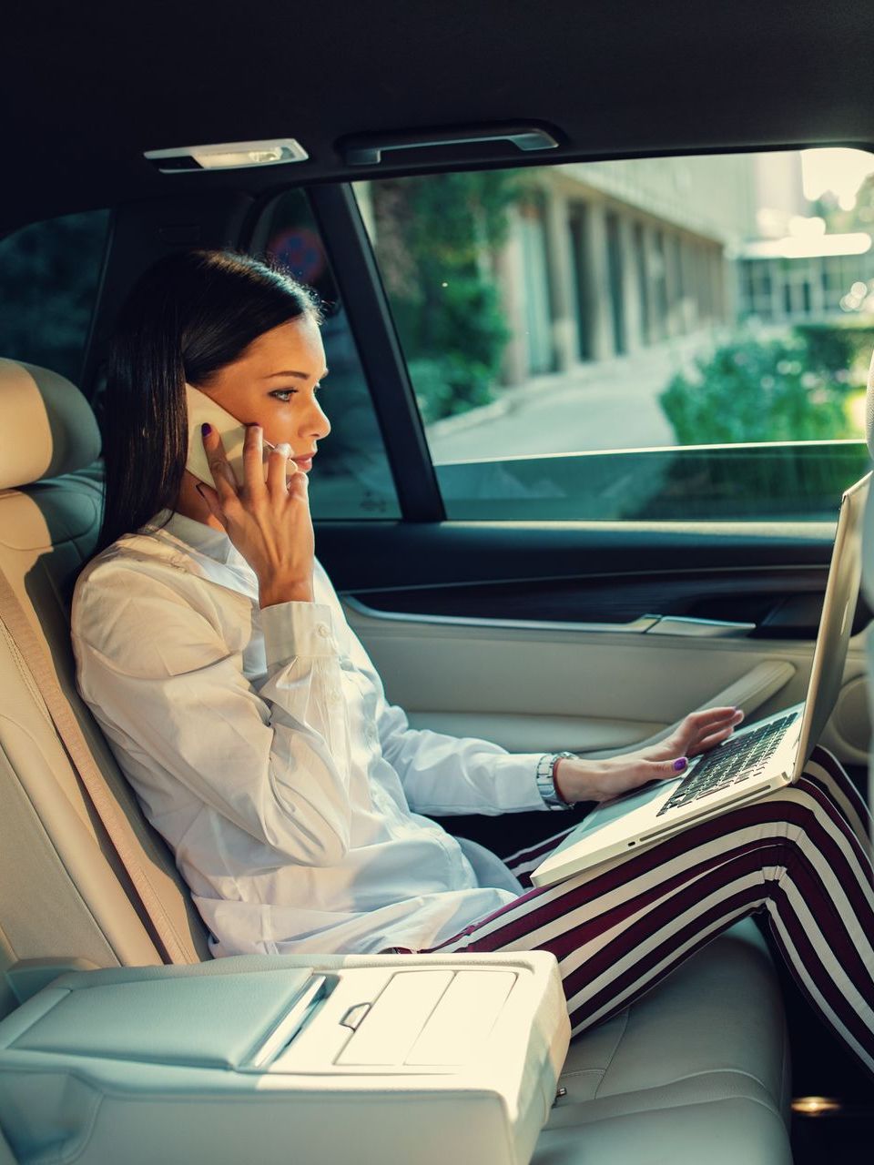business woman talking on the phone in the car