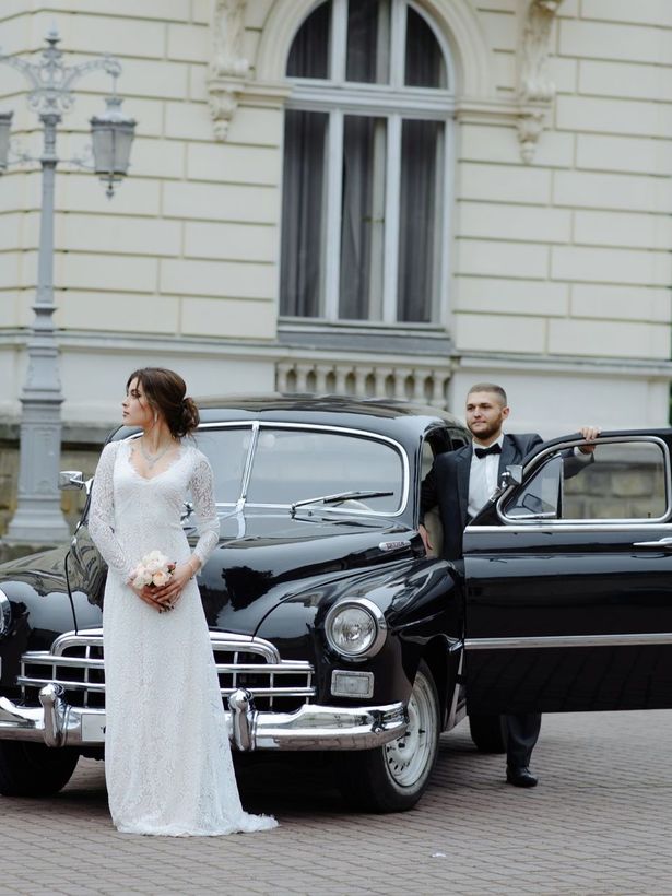 couple with a luxury car