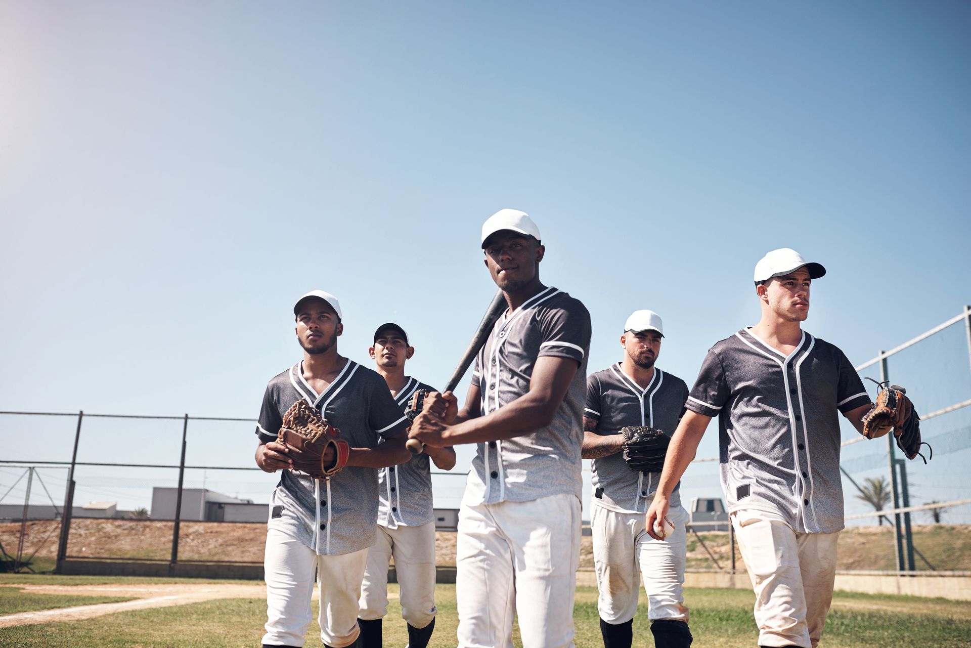 A group of baseball players are standing on a field.