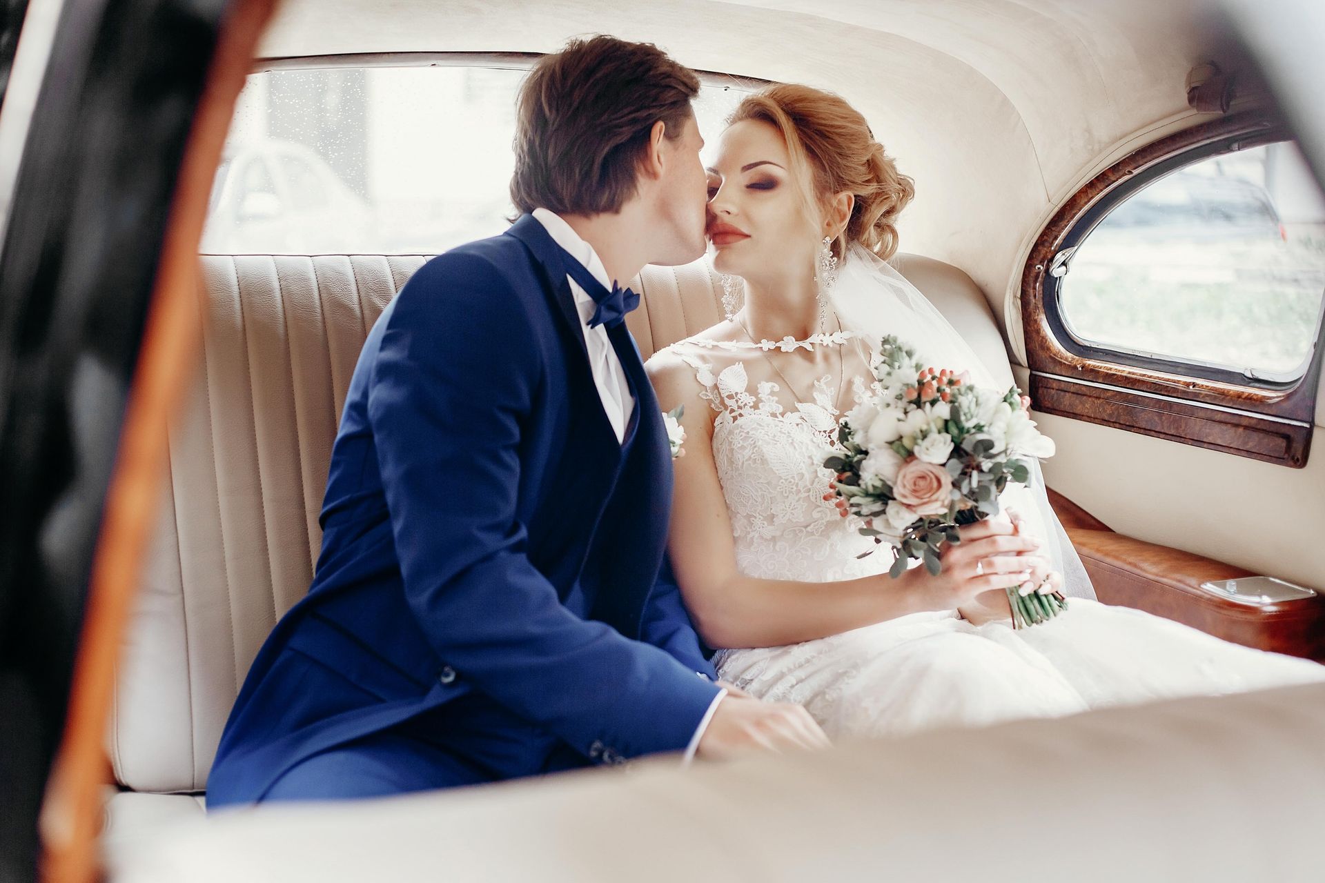 bride and groom in a luxury vintage car
