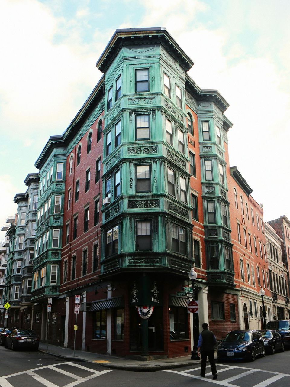 A white house with a wooden fence in front of it