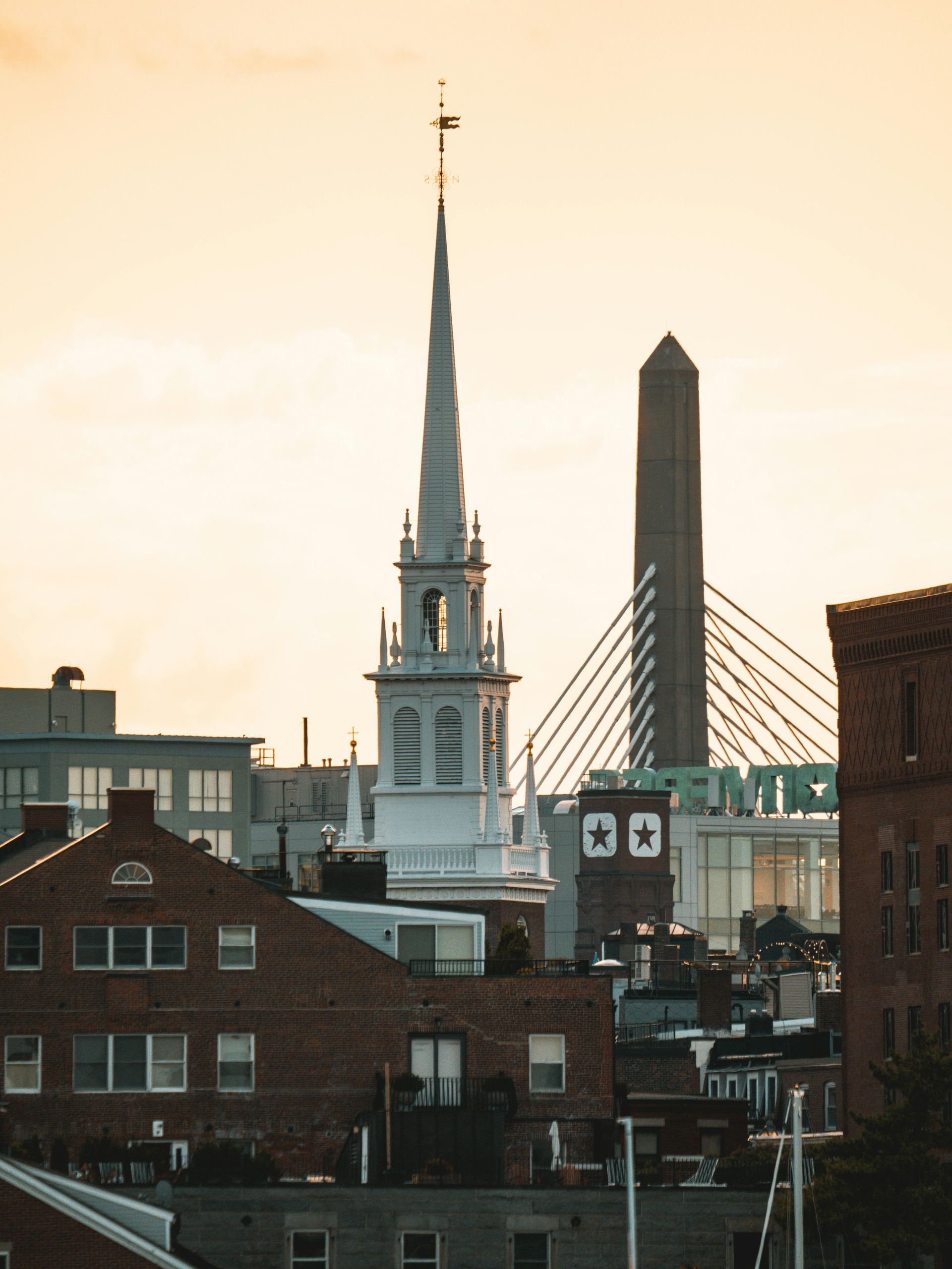 Ducks are swimming in a lake with a washington monument in the background.