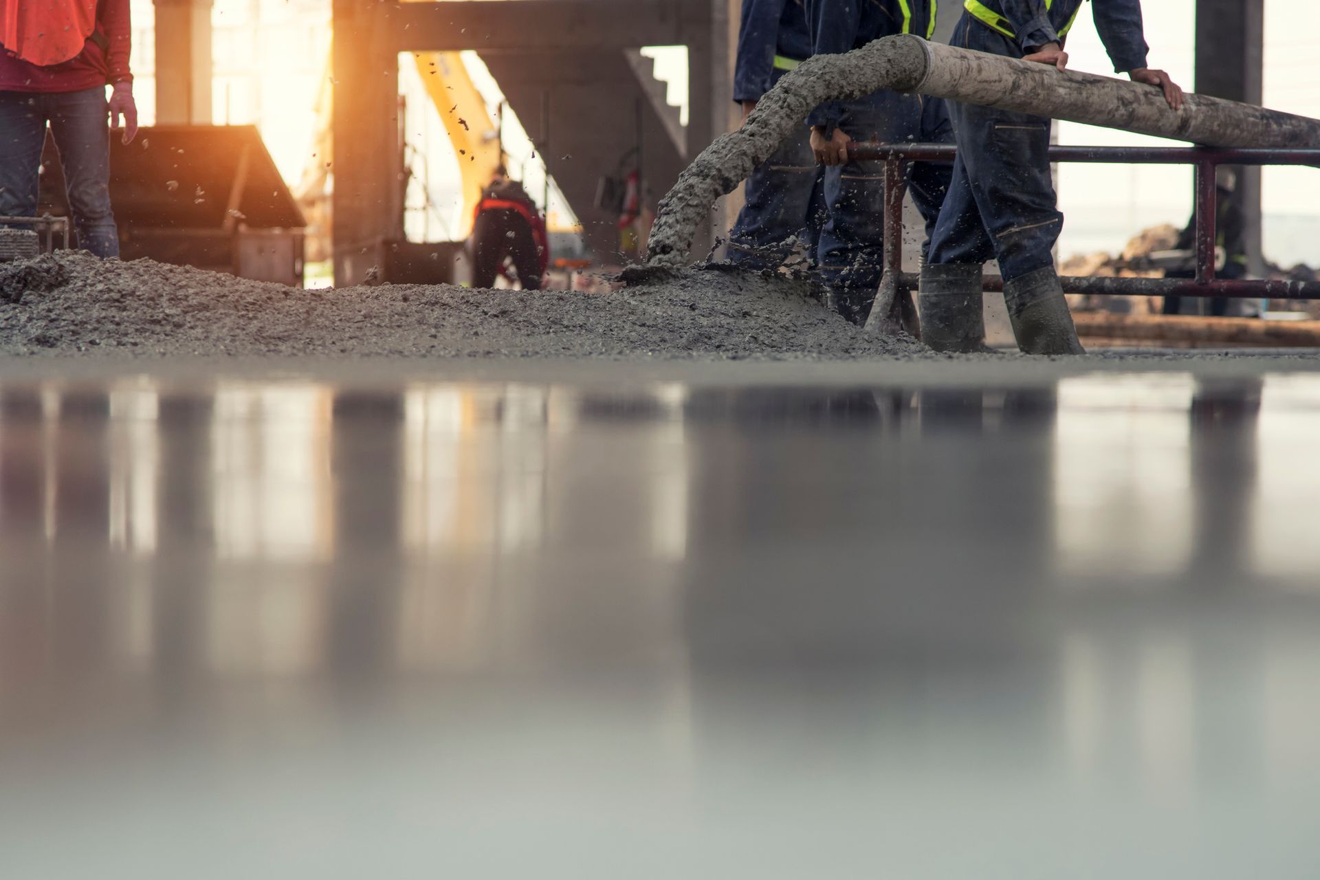 Civil concrete pumping performed by a construction worker on a floor of building in construction.
