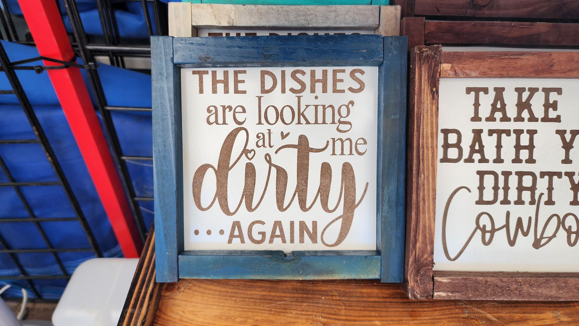 A wooden sign that says `` the dishes are looking at me dirty again ''