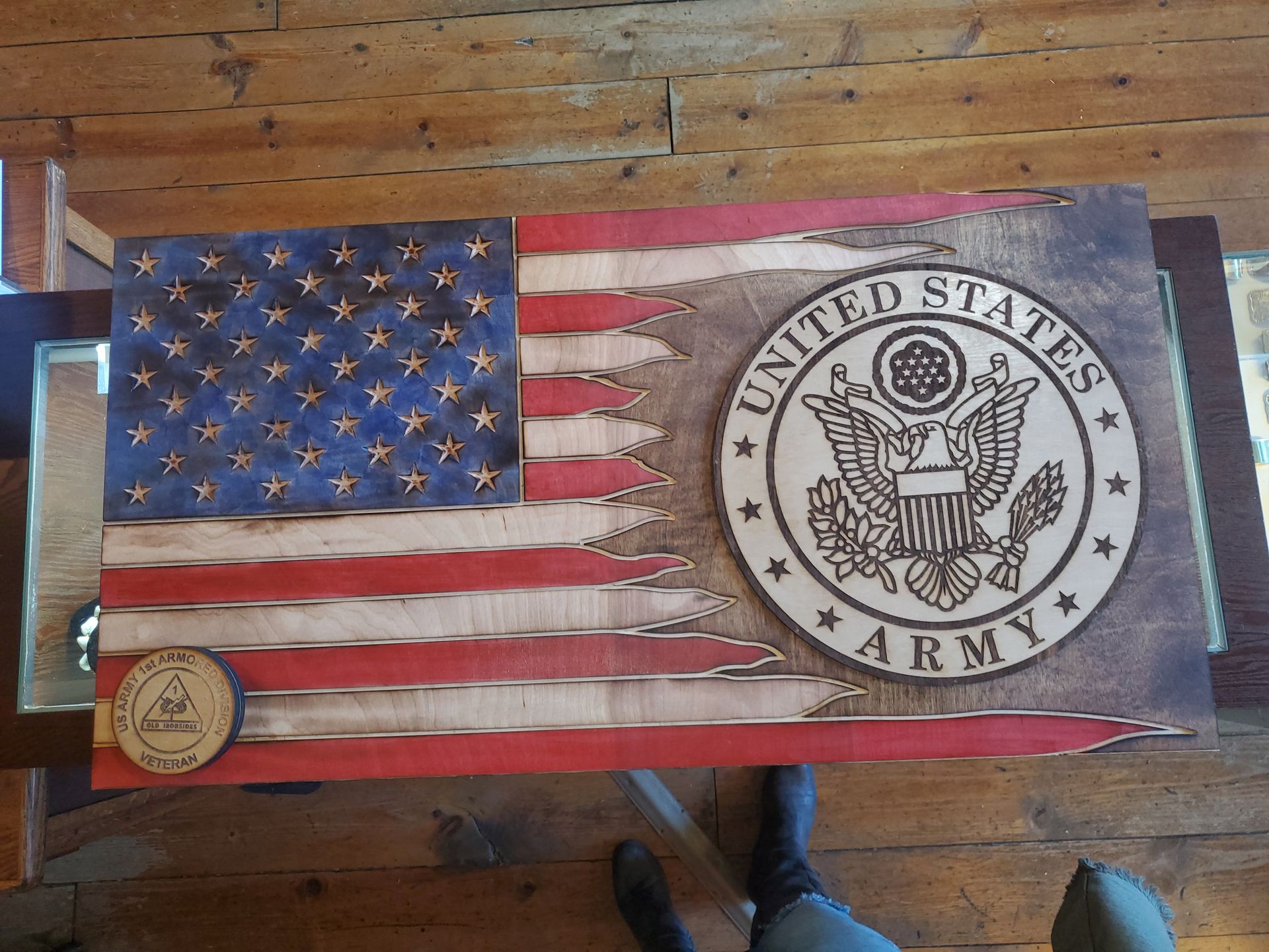 A united states army flag is on a wooden table