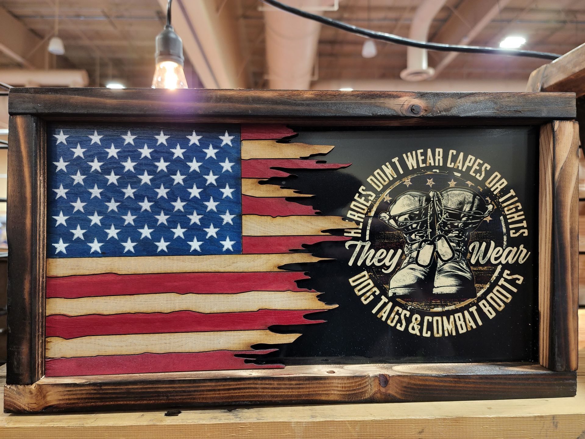 A wooden american flag with the words `` they wear dog tags and combat boots ''