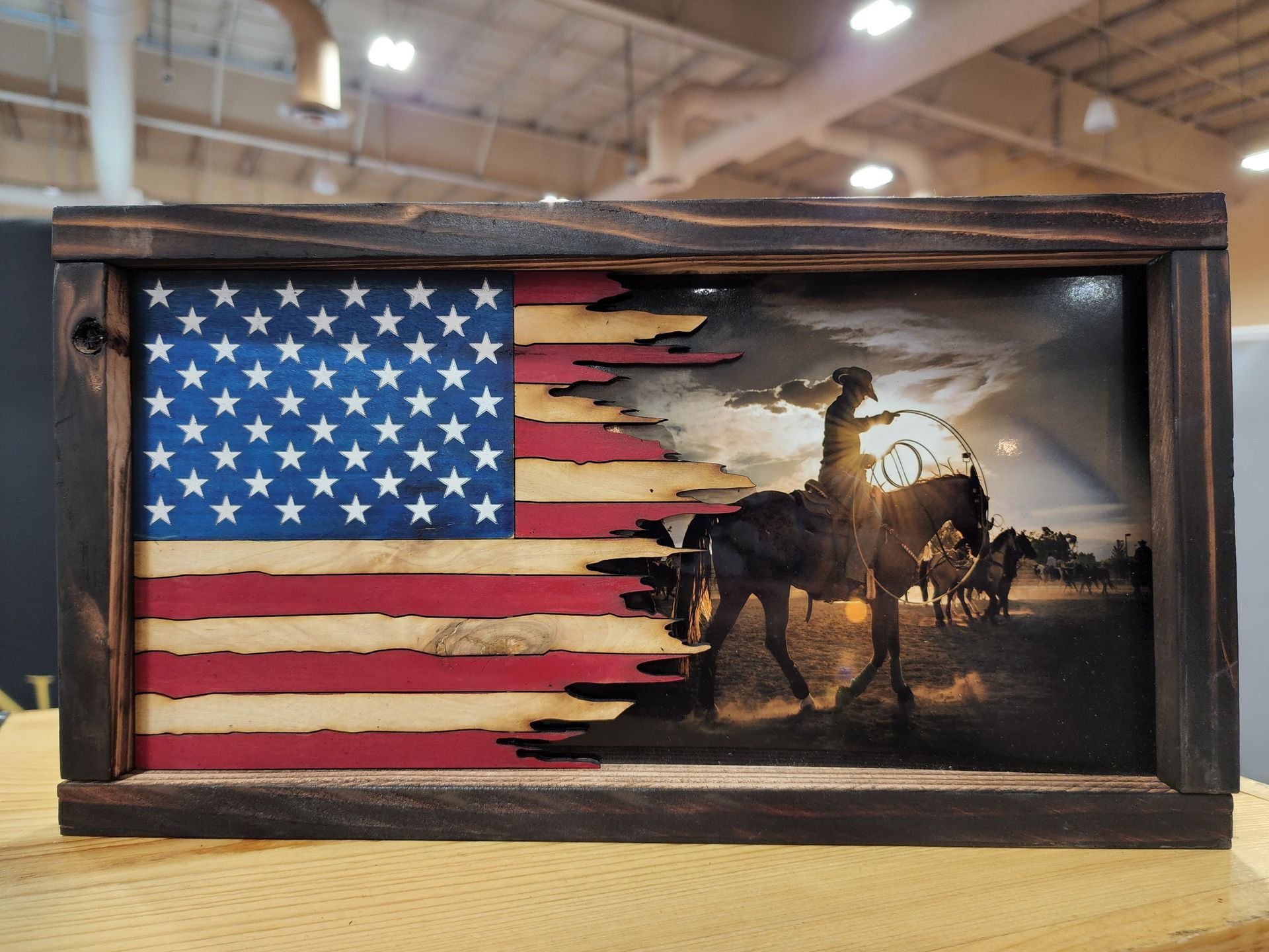 An american flag with a picture of a cowboy on a horse