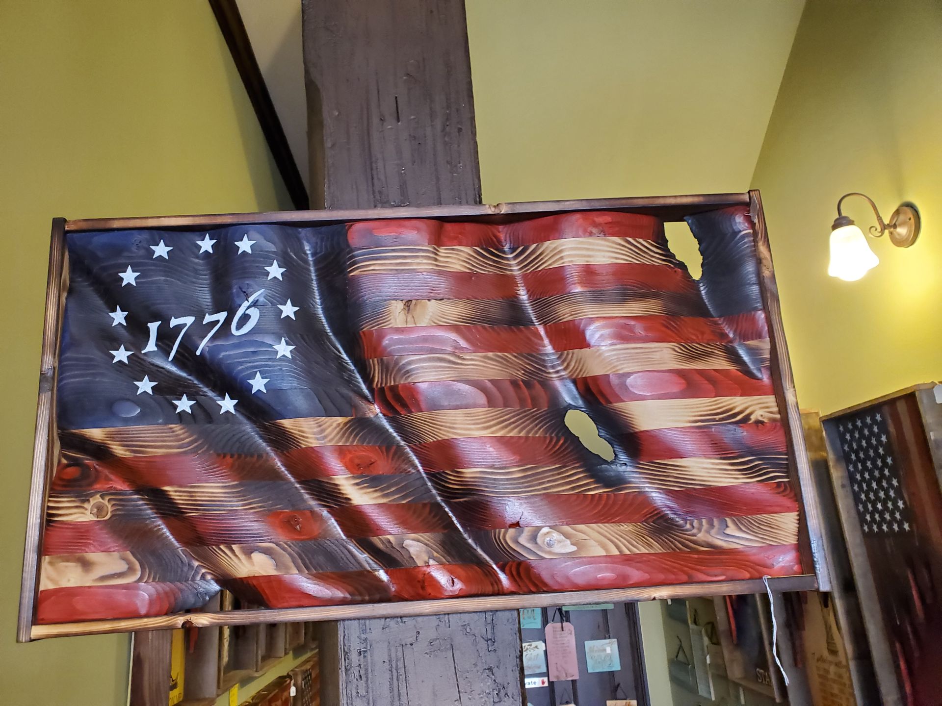 A wooden american flag with the year 1776 on it