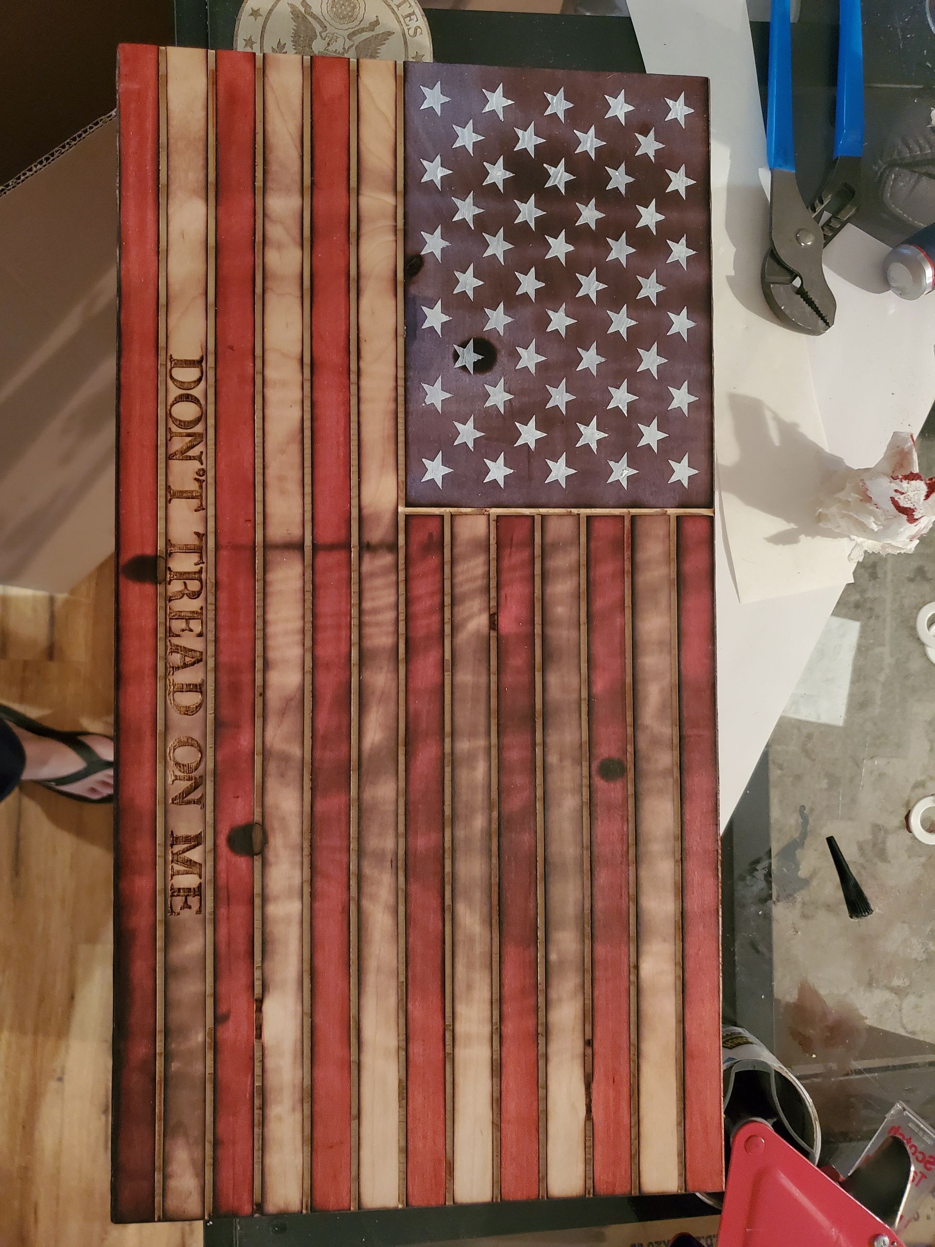 A wooden american flag with the words `` do n't tread on me '' written on it