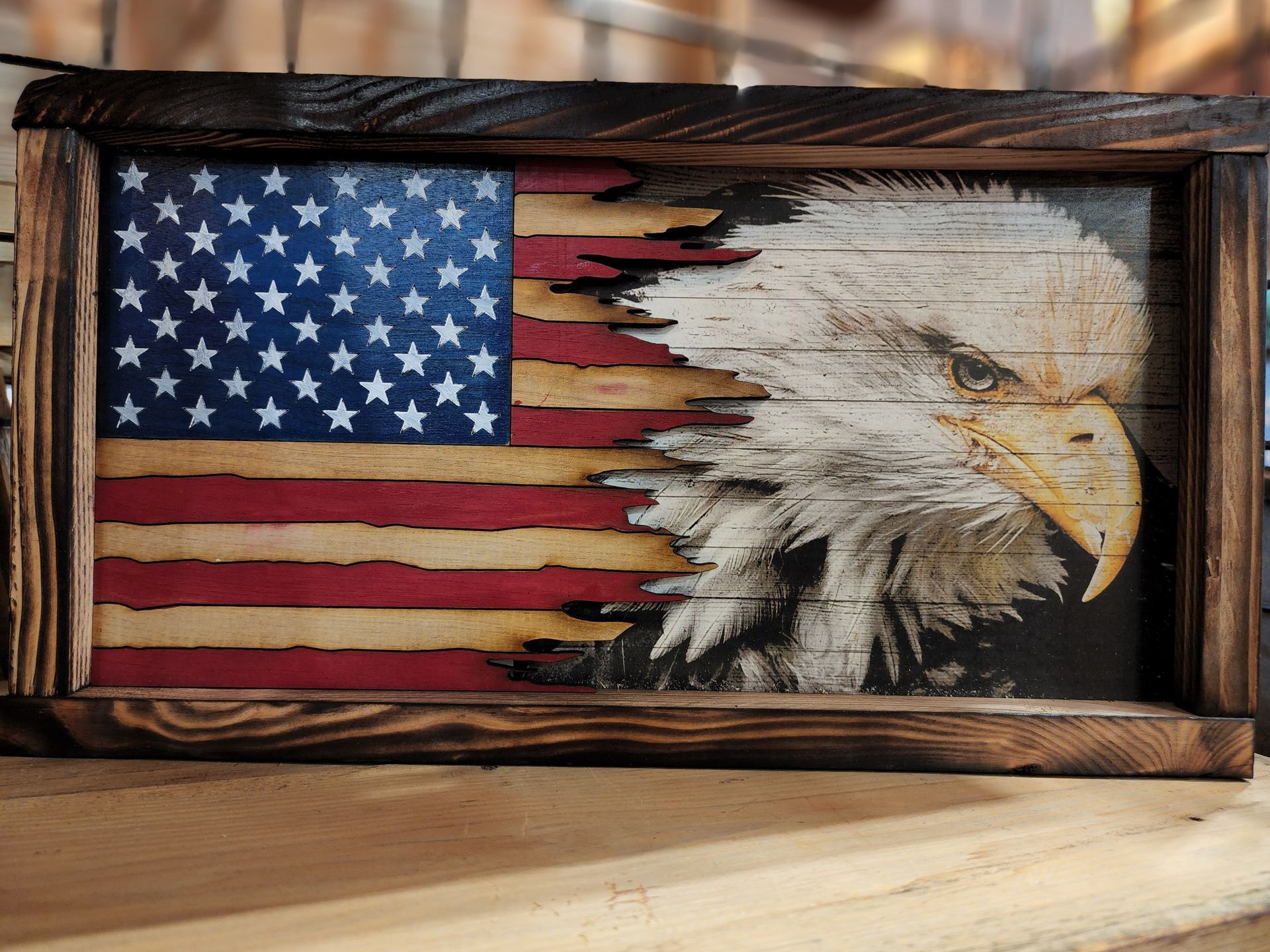 A wooden american flag with an eagle on it.