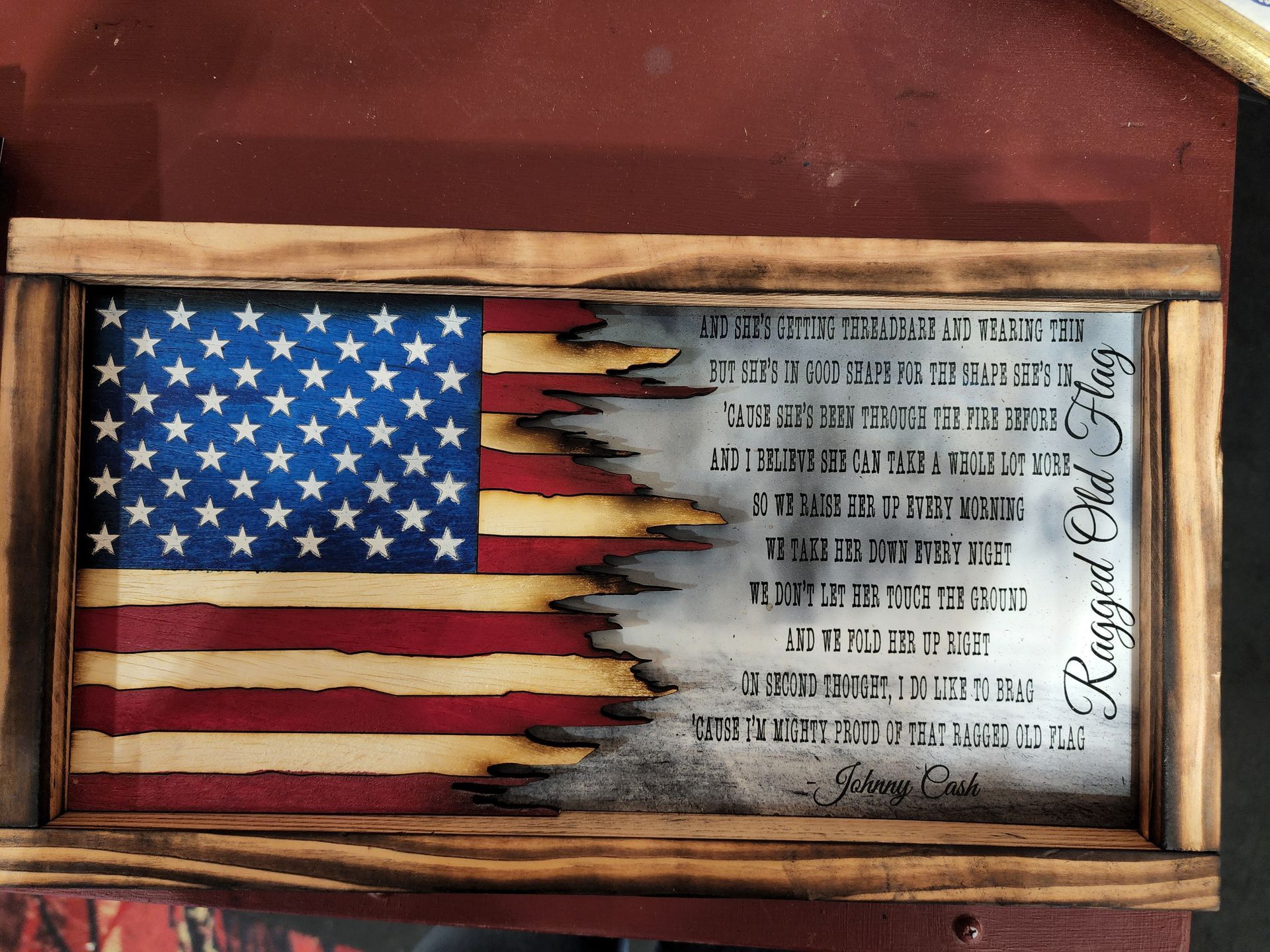 A wooden american flag with a poem on it
