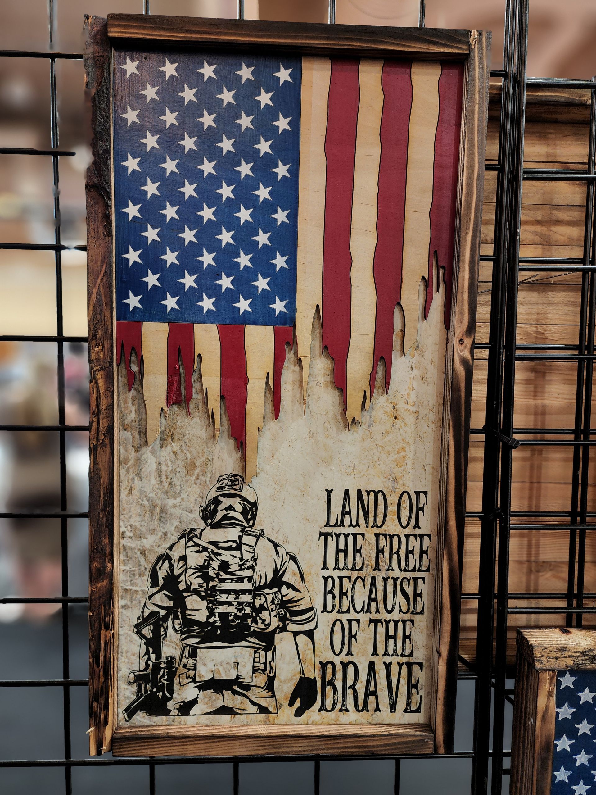 A sign that says land of the free because of the brave