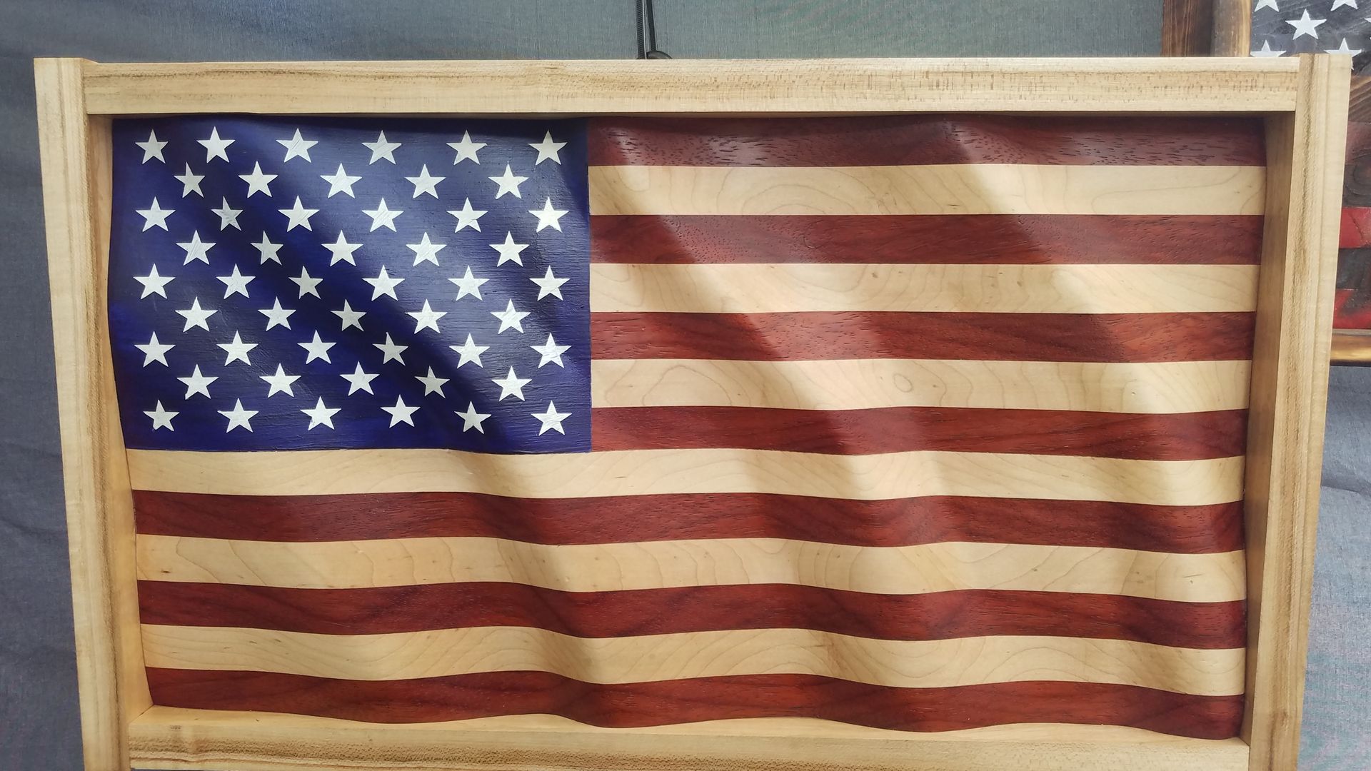 A wooden american flag is sitting on a table.