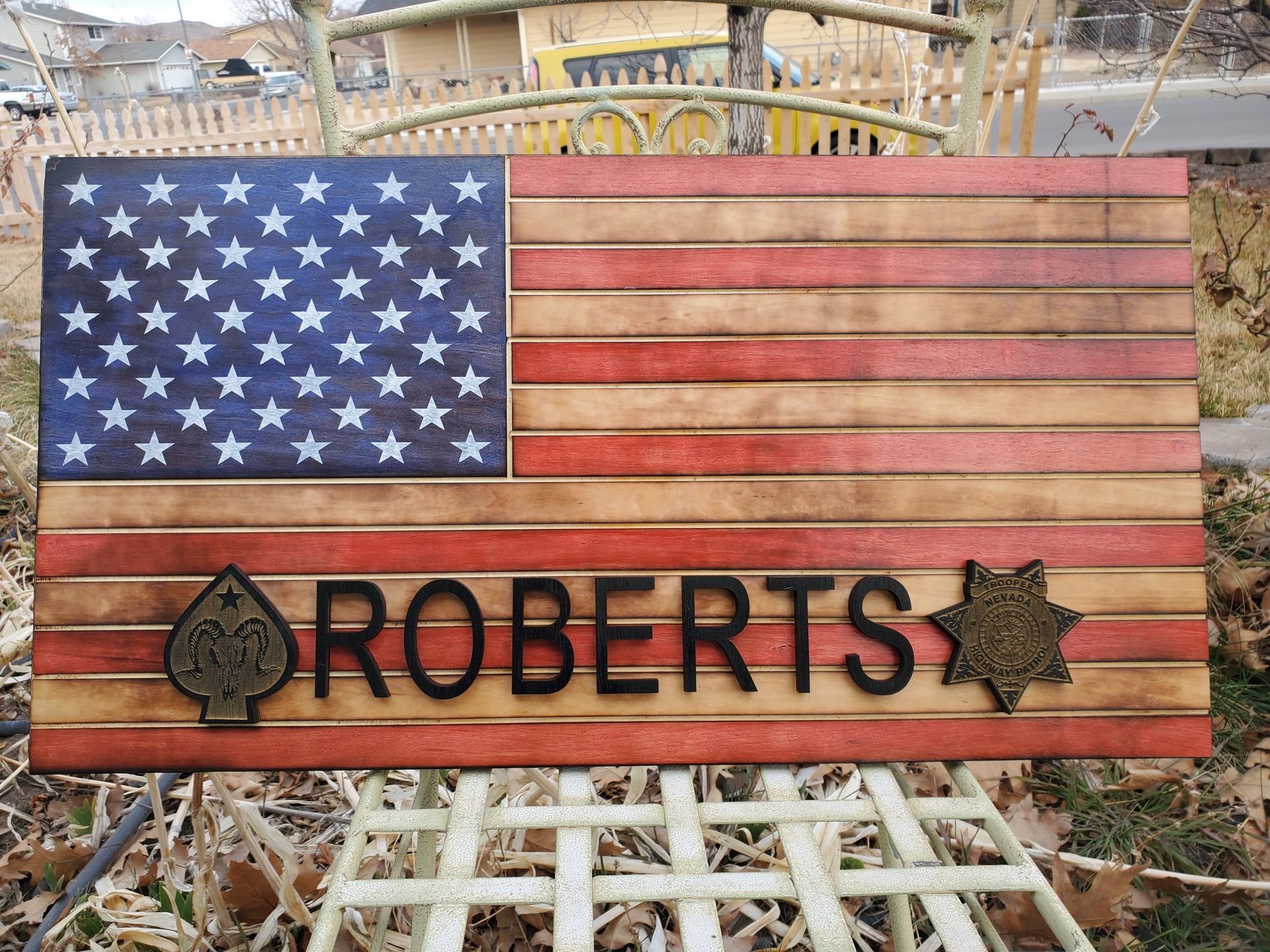 A wooden american flag with the name roberts on it