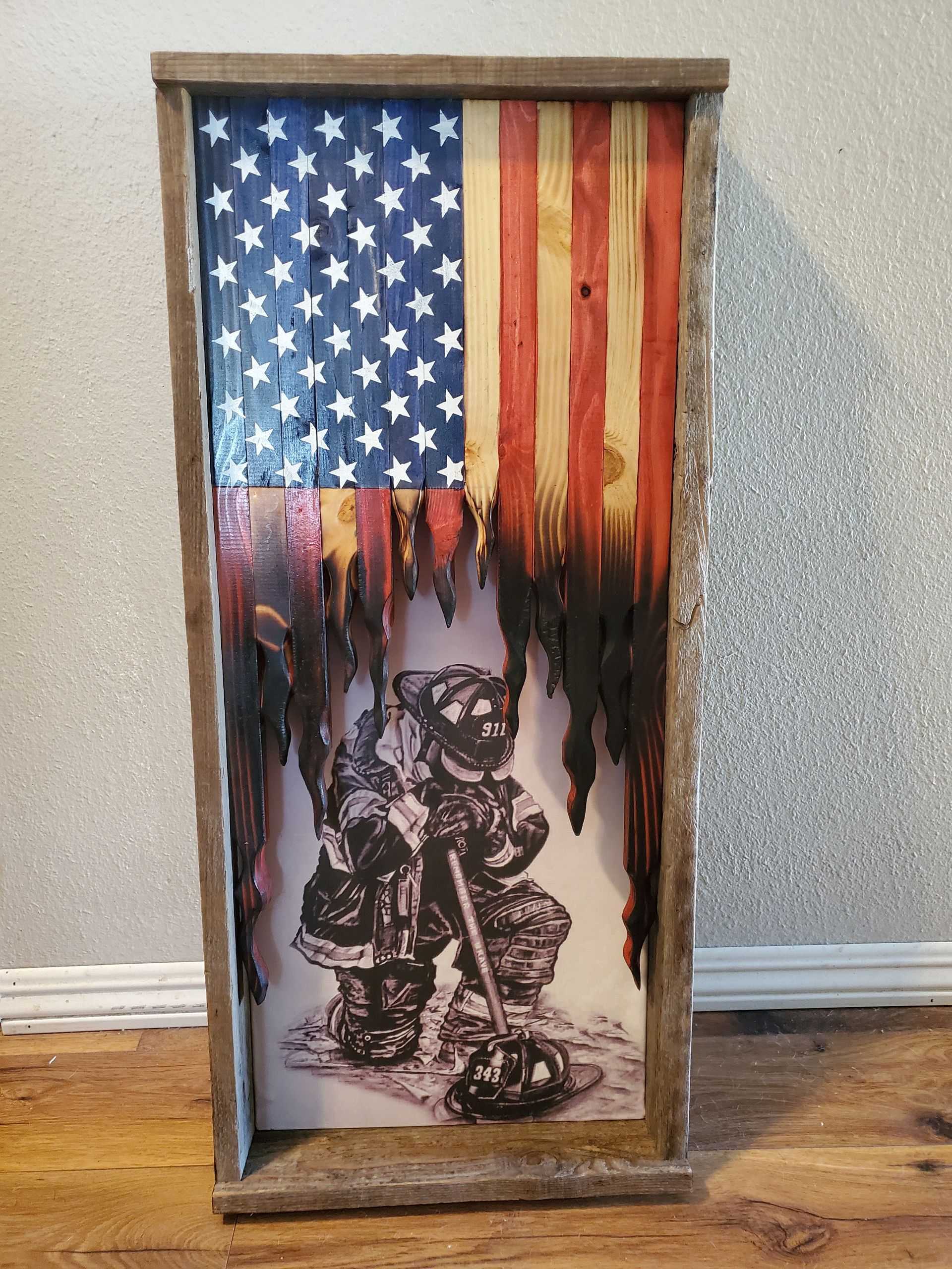A painting of a firefighter with an american flag behind him