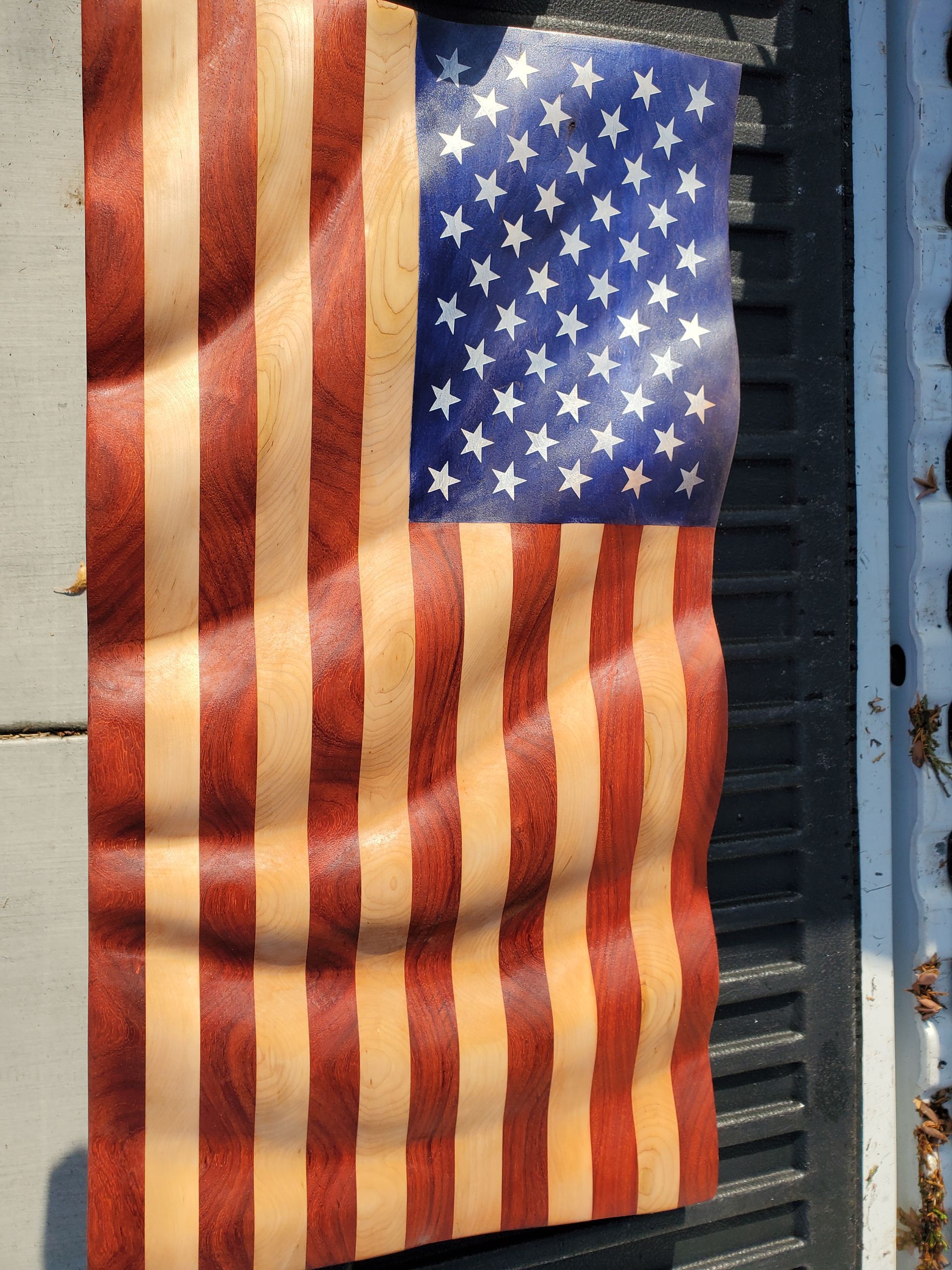 A wooden american flag is waving in the wind