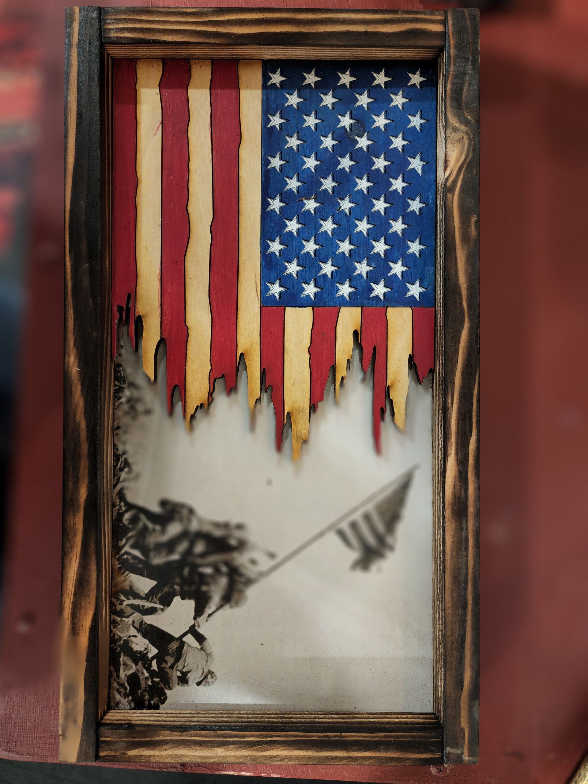 A picture of an american flag in a wooden frame