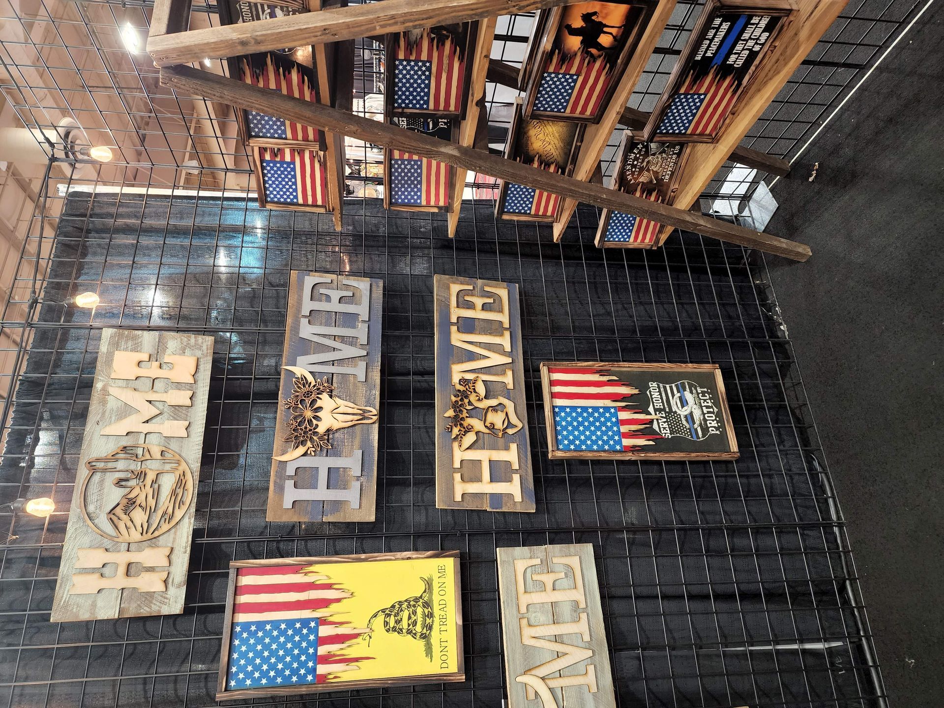 A bunch of signs hanging on a wall with one that says home