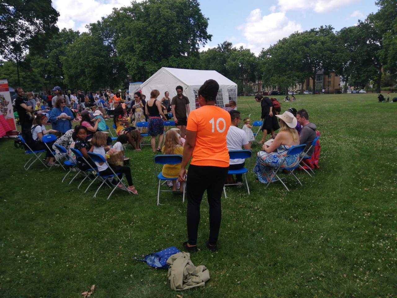 A woman wearing an orange shirt with the number 10 on it