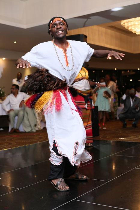 A man in a white shirt is dancing on a dance floor