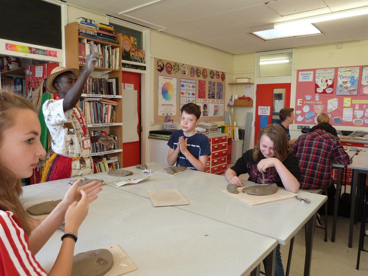 A group of children are sitting around a table in a classroom