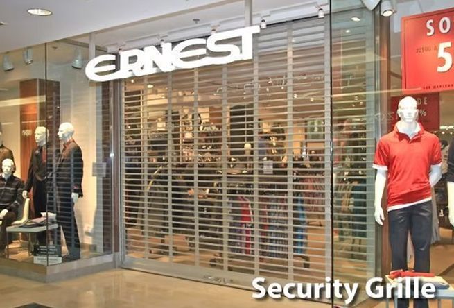 A store front with a security grille that says ernest